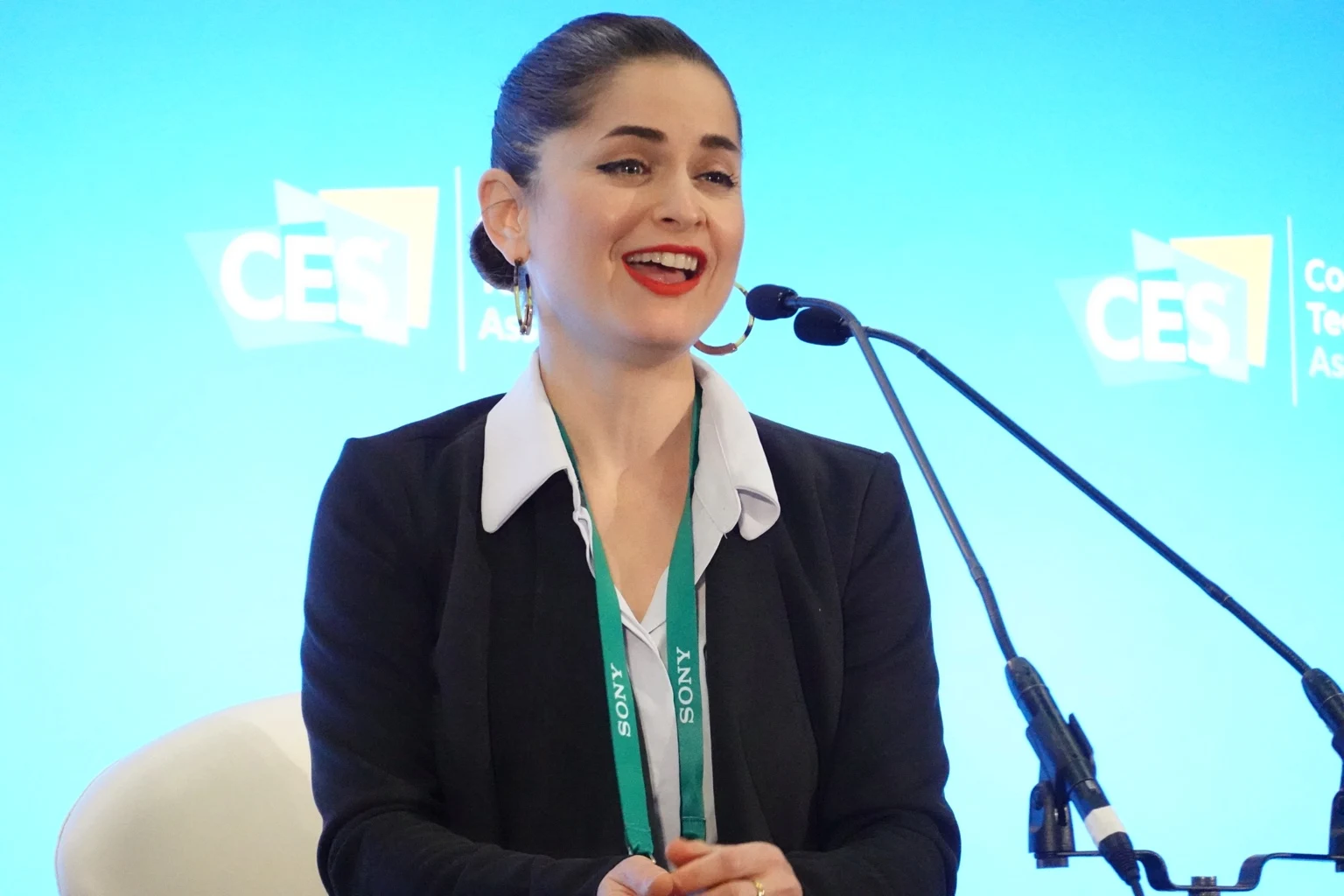 Hamutal speaking with a microphone at CES